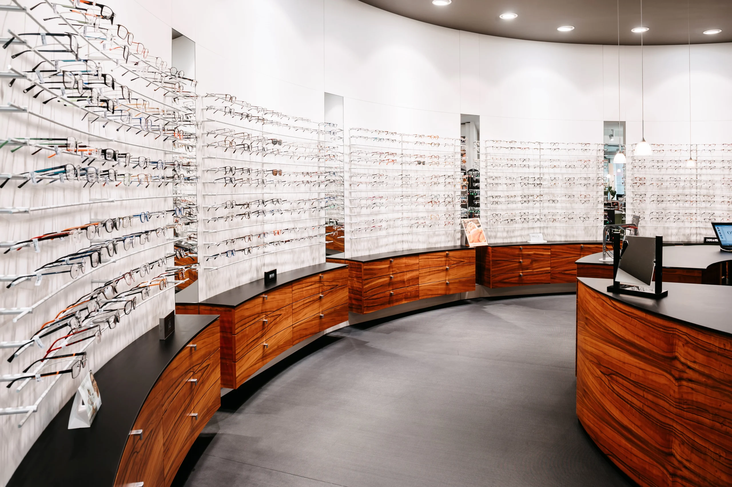 Intérieur du magasin et ses présentoirs à lunettes de vue et commodes en bois